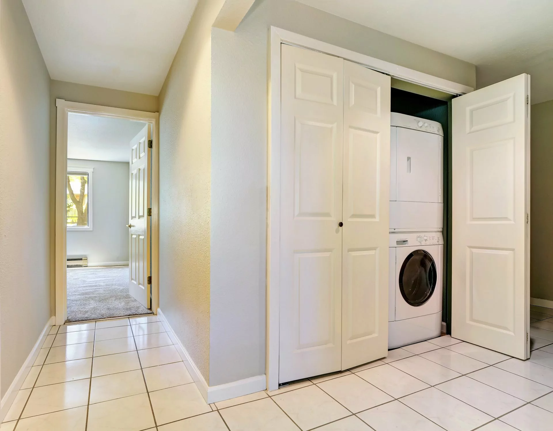 Miejsce dla pralki,Pralka w szafie gospodarczej,pralka w przedpokoju, pralka i suszarka schowana za białymi drzwiami w korytarzu