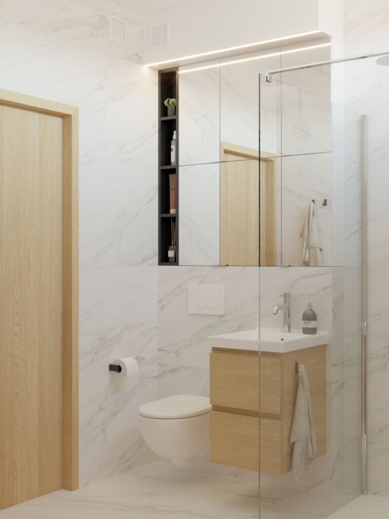 Biała łazienka w bloku z lustrem nad umywalką- Warszawa