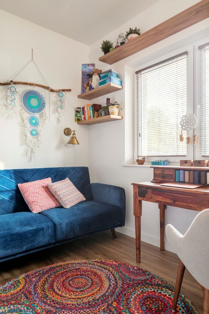 Niebieska Kanapa W Pracowni Damskiej Stylowa niebieska kanapa w pracowni, tworząca przytulny kącik.